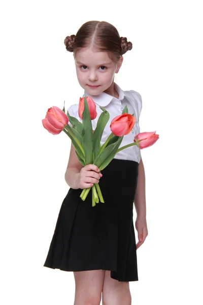Estudante bonito com um buquê de tulipas — Fotografia de Stock
