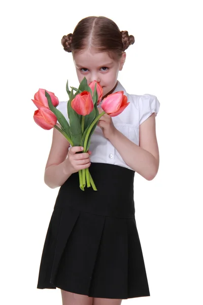 Estudante bonito com um buquê de tulipas — Fotografia de Stock