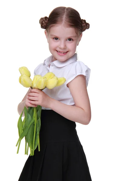 Cute schoolgirl with a bouquet of tulips — Stock Photo, Image