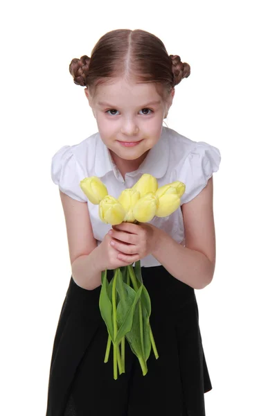 Cute schoolgirl with a bouquet of tulips — Stock Photo, Image