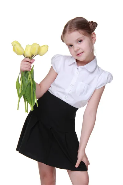 Söt skolflicka med en bukett tulpaner — Stockfoto