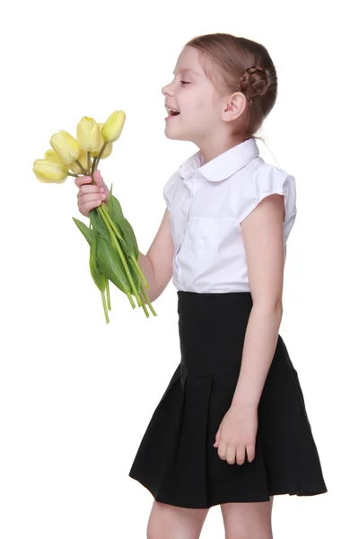 Estudante bonito com um buquê de tulipas — Fotografia de Stock