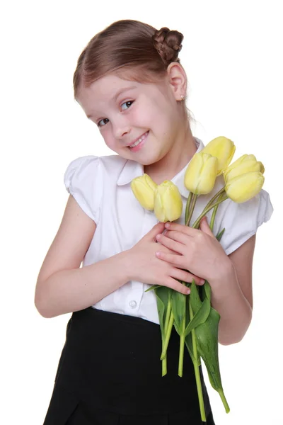 Estudante bonito com um buquê de tulipas — Fotografia de Stock