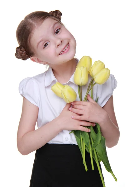 Estudante bonito com um buquê de tulipas — Fotografia de Stock