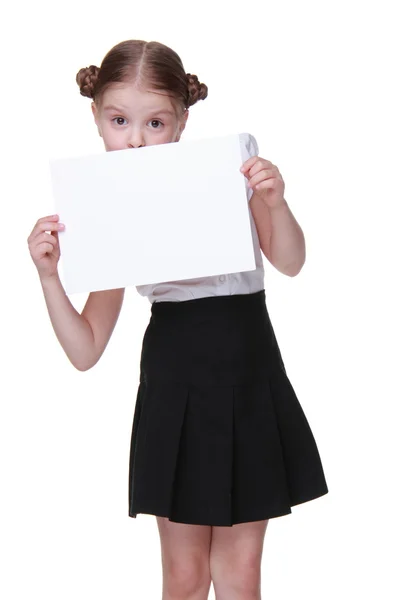 Happy schoolgirl with a sheet of paper — Stock Photo, Image