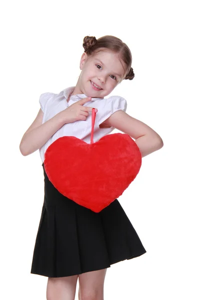 Caucasian schoolgirl with red heart symbol — Stock Photo, Image