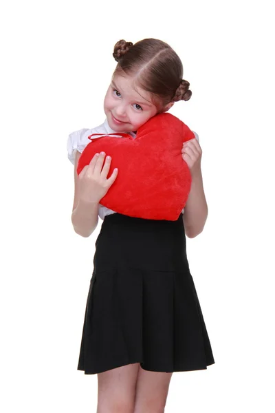 Caucasian schoolgirl with red heart symbol — Stock Photo, Image