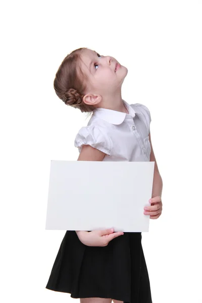 Gelukkig schoolmeisje met een vel papier — Stockfoto