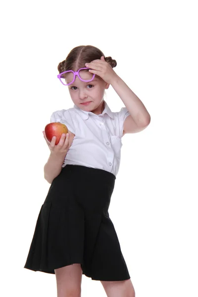 Portrait of a schoolgirl in glasses holding an apple — Stock Photo, Image