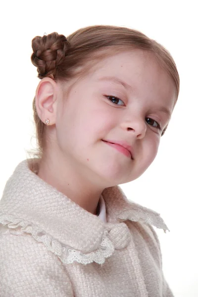 Studio portrait of a happy girl in a light coat — Zdjęcie stockowe