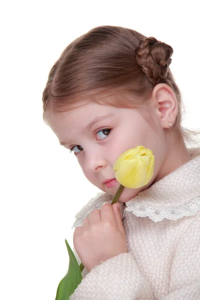 Studio portrait of a little girl with a yellow tulip — Stock Photo, Image