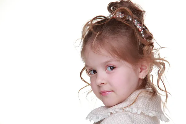 Portrait of cute little girl in a light coat — Zdjęcie stockowe