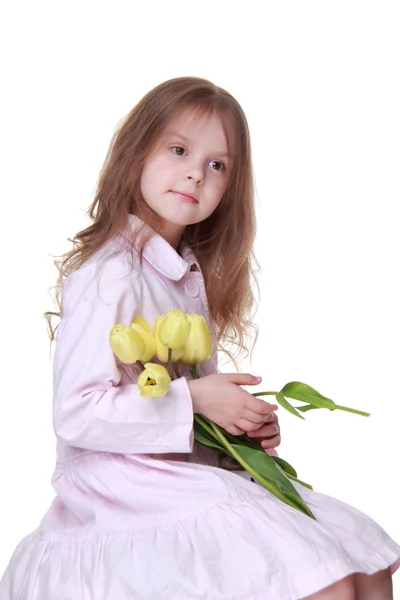 Menina bonito em um vestido com um buquê de tulipas — Fotografia de Stock