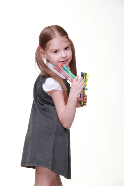 Studio portrait of schoolgirl with felt-tip pens — Stock Photo, Image