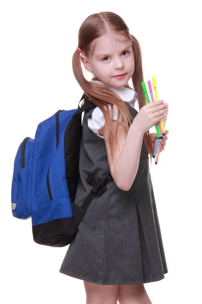 Studio portrait of girl with schoolbag holding felt-tip pens — Stock Photo, Image