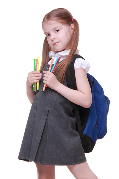 Studio portrait of girl with schoolbag holding felt-tip pens — Stock Photo, Image