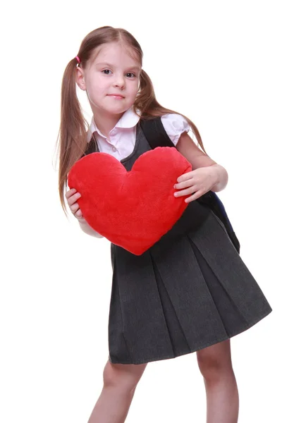 Caucasian schoolgirl with red heart symbol — Stock Photo, Image