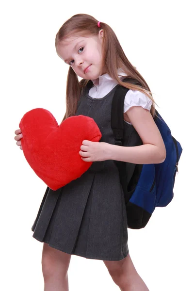 Кавказская школьница с красным сердцем — стоковое фото