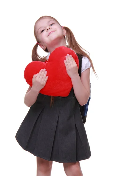 Kaukasische schoolmeisje met rood hartsymbool — Stockfoto