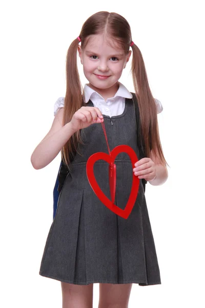 Caucasian lovely schoolgirl holding red heart symbol — Stock Photo, Image