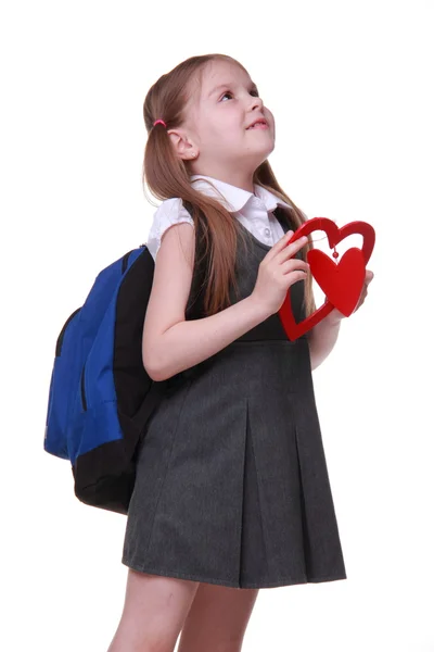 Caucasico giovane ragazza con schoolbag holding cuore — Foto Stock