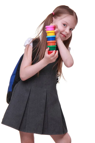 Carino piccola studentessa in abito scuro con acquerello in mano — Foto Stock