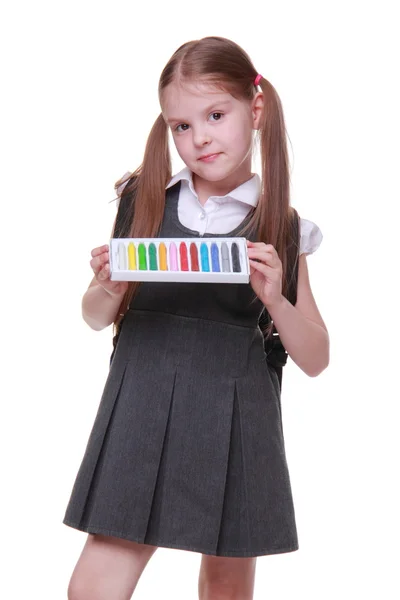 Beautiful little girl in dress holding color chalks — Stock Photo, Image