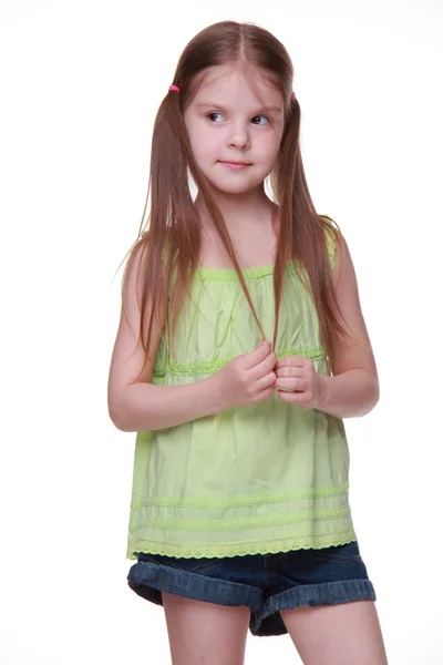 Студийный портрет маленькой девочки в зеленой рубашке — стоковое фото