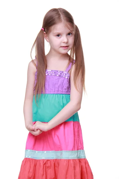 Little girl in a colorful dress posing in studio — Stock Photo, Image