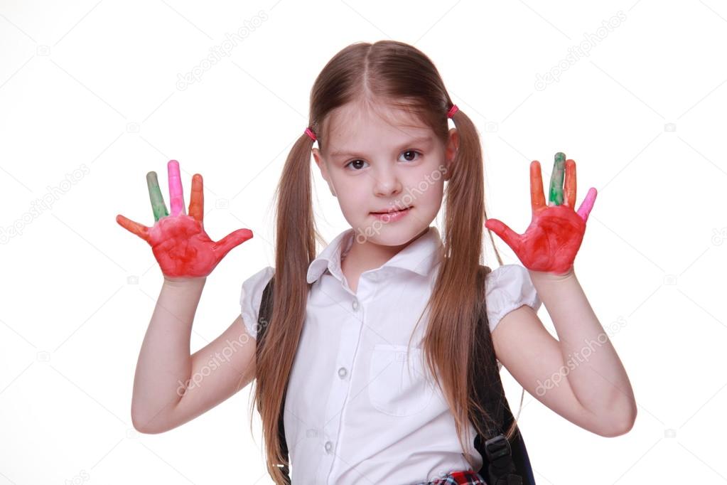 Happy little girl with paints on hands
