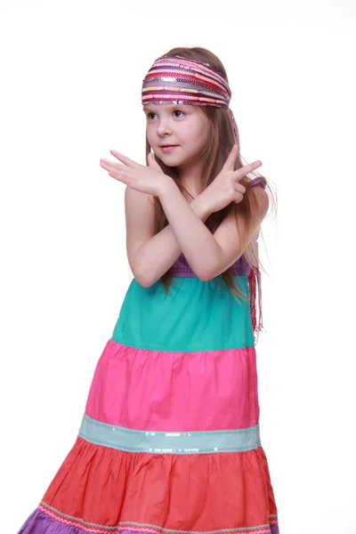 Little girl in a lovely colorful dress dancing in studio — Stock Photo, Image