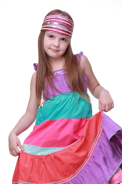 Little girl in a colorful dress posing in studio — Stock Photo, Image