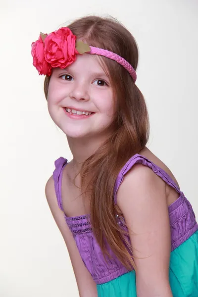 Portrait of little girl with flower on her head — Stock Photo, Image