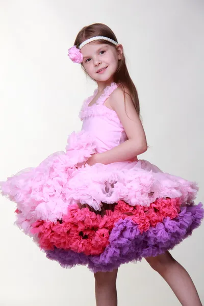 Маленькая девочка в розовом платье танцует изолирован на белом фоне — стоковое фото