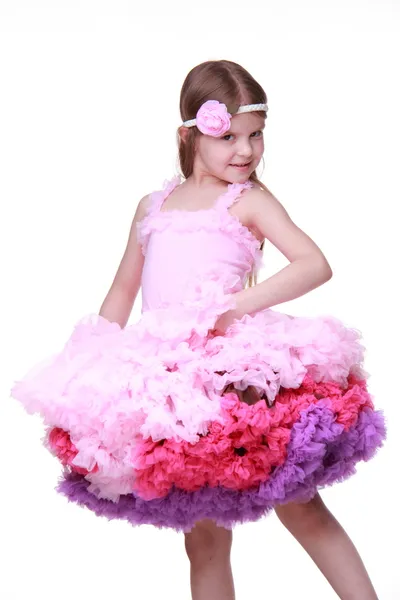 Little girl in a pink dress dancing isolated on a white background — Stock Photo, Image