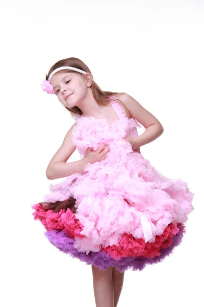 Little girl in a pink dress dancing isolated on a white background — Stock Photo, Image