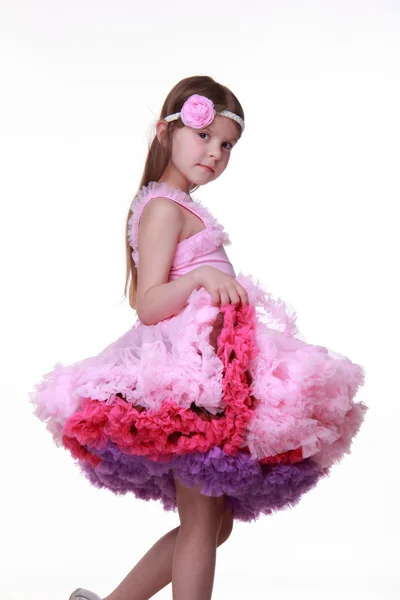 Beautiful little girl in a lovely pink dress isolated on a white background — Stock Photo, Image