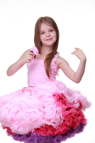 Little girl in a pink dress dancing isolated on a white background — Stock Photo, Image