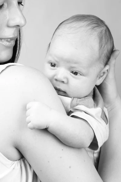 Черно-белое фото красивой матери с маленьким мальчиком на руках — стоковое фото