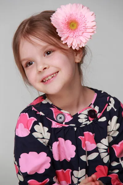 Studio portrait of a young girl with beautiful hairstyle of fresh gerbera — Stock Photo, Image