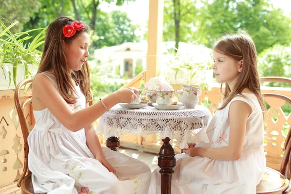 Outdoor image of beautiful little girls with tea — Stock Photo, Image