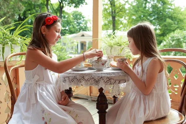 Outdoor image of beautiful little girls with tea — Stock Photo, Image