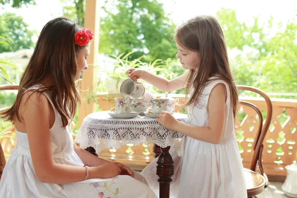 Outdoor image of beautiful little girls with tea — Stock Photo, Image