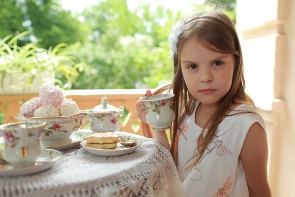 Outdoor image of beautiful little girls with tea — Stock Photo, Image