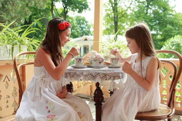 Outdoor image of beautiful little girls with tea — Stock Photo, Image