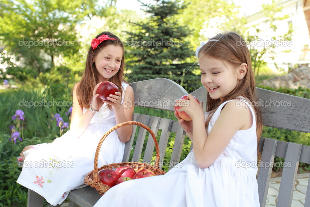 Portrait of lovely girls with red apples