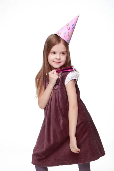 Joyful girl is holding fife on birthday party — Stock Photo, Image