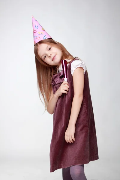 Cute little girl in adorable pink dress with fife and holiday hat isolated on white background Image of pretty joyful kid girl on birthday party — Stock Photo, Image