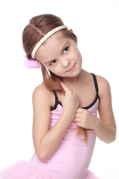 粉色的芭蕾舞裙站在芭蕾舞姿微笑着的小舞者的肖像 — 图库照片