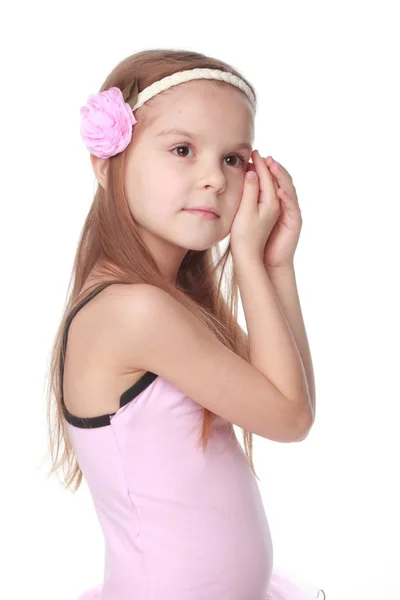 Cute little ballet dancer with beautiful hair standing in a ballet pose — Stock Photo, Image